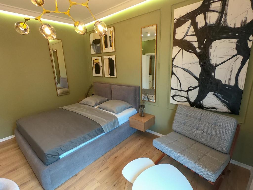 1 dormitorio con 1 cama y 1 silla en Roza's Studio Tirana Center, en Tirana