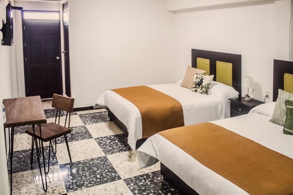 Postel nebo postele na pokoji v ubytování Múcara hotel