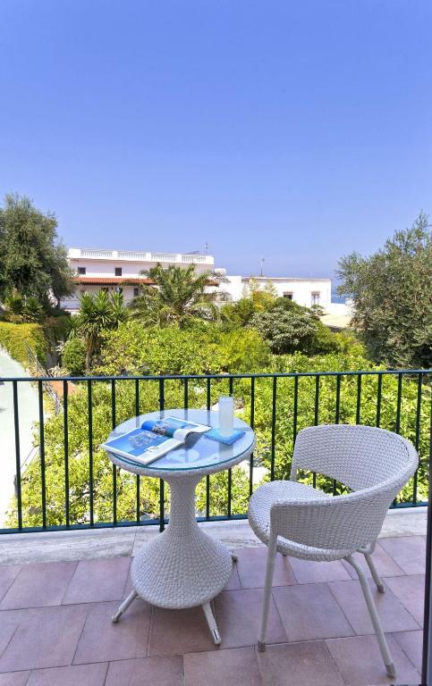 a table and two chairs on a balcony at Casa Vacanze Parco Del Generale in Ischia