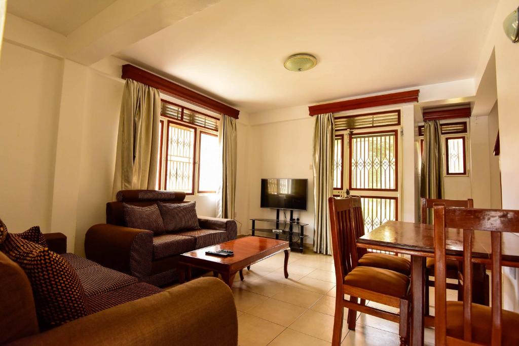 a living room with a couch and a table at Crane Serviced Apartments in Entebbe