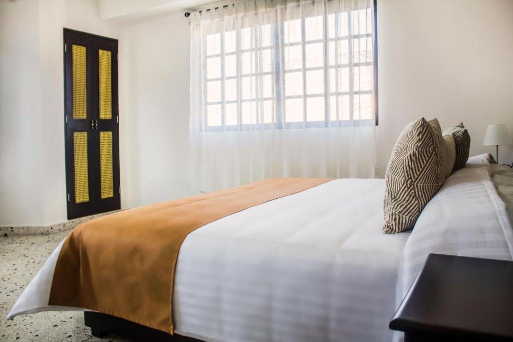Postel nebo postele na pokoji v ubytování Múcara hotel