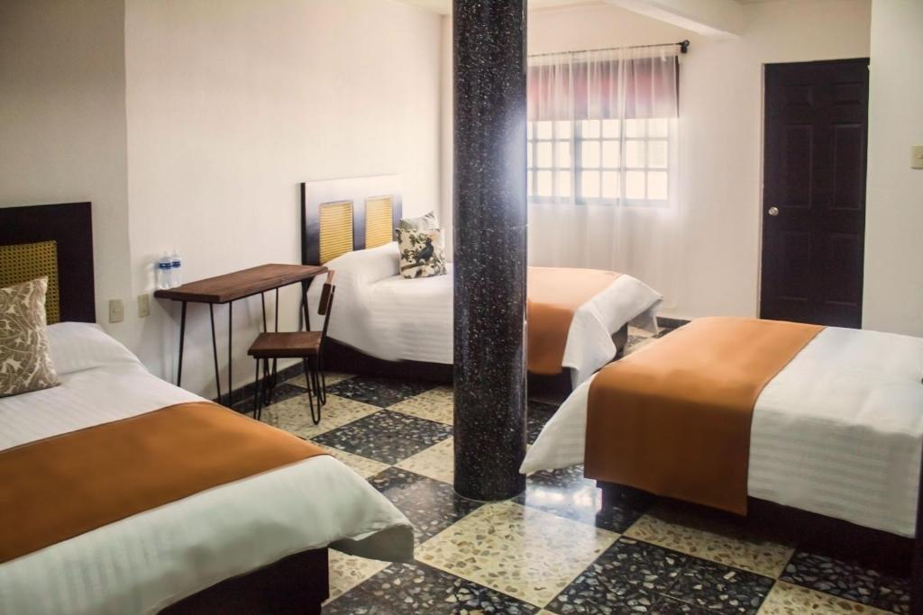 Postel nebo postele na pokoji v ubytování Múcara hotel