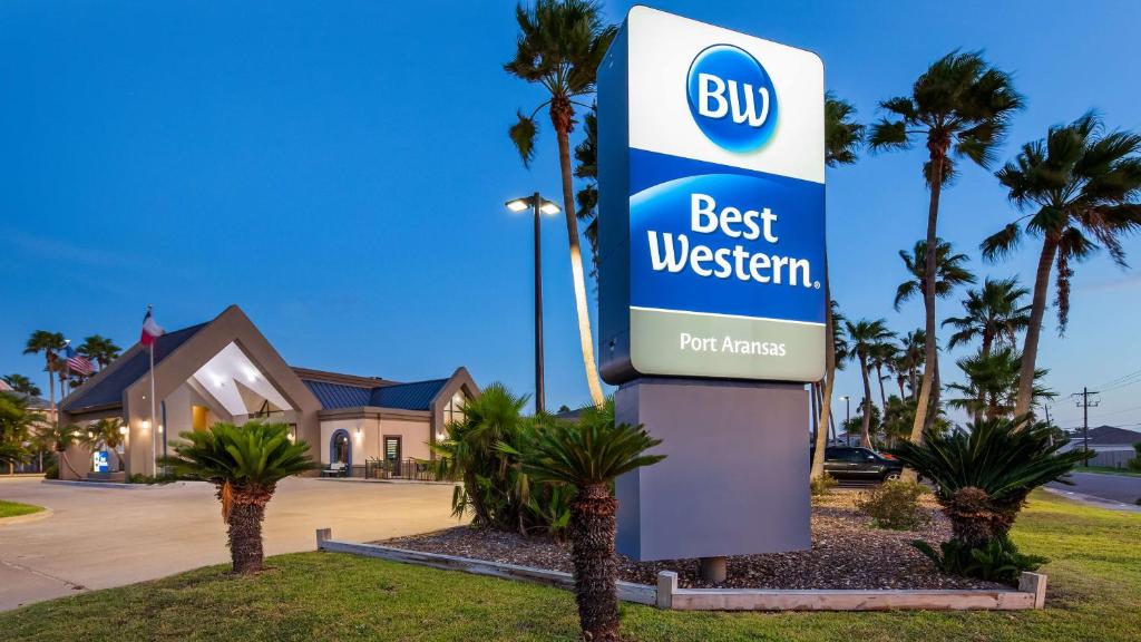 a sign for a bus best western in front of a house at Best Western Port Aransas in Port Aransas