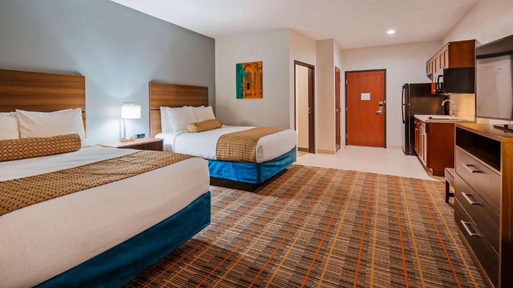 a hotel room with two beds and a kitchen at Best Western Ingleside Inn & Suites in Ingleside