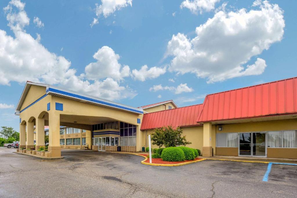 a building with a red roof and a parking lot at Econo Lodge Inn & Suites Triadelphia - Wheeling in Triadelphia