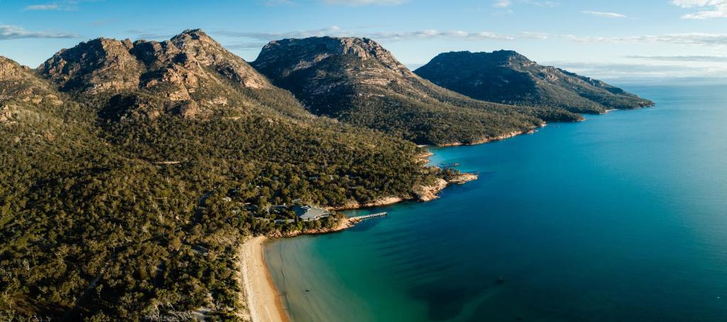 an aerial view of a beach and mountains at Freycinet Lodge in Coles Bay