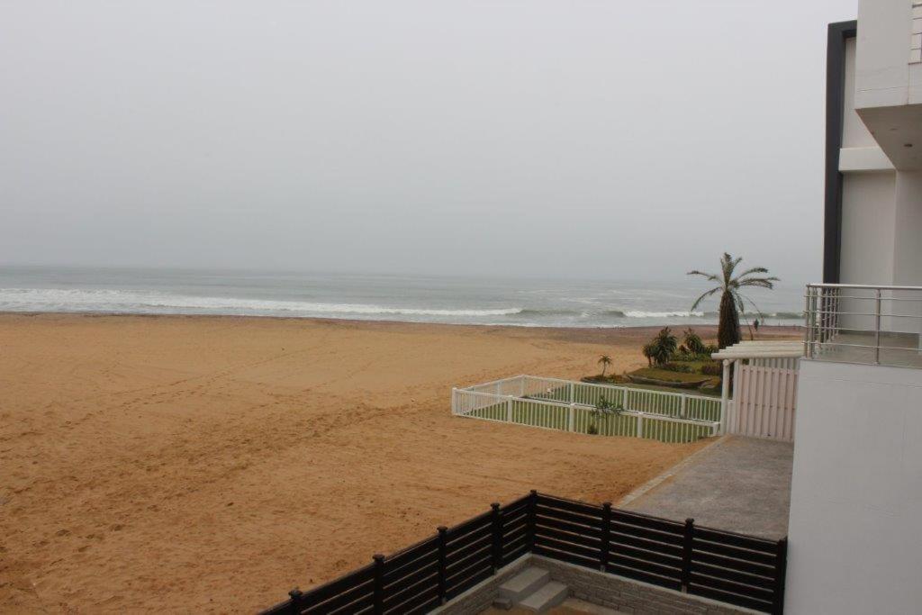 a view of the beach from the balcony of a building at Zee Sicht in Swakopmund