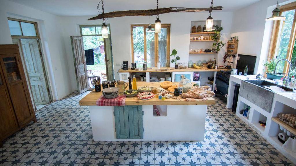 a kitchen with a counter with food on it at Karma Hostel in Martvili