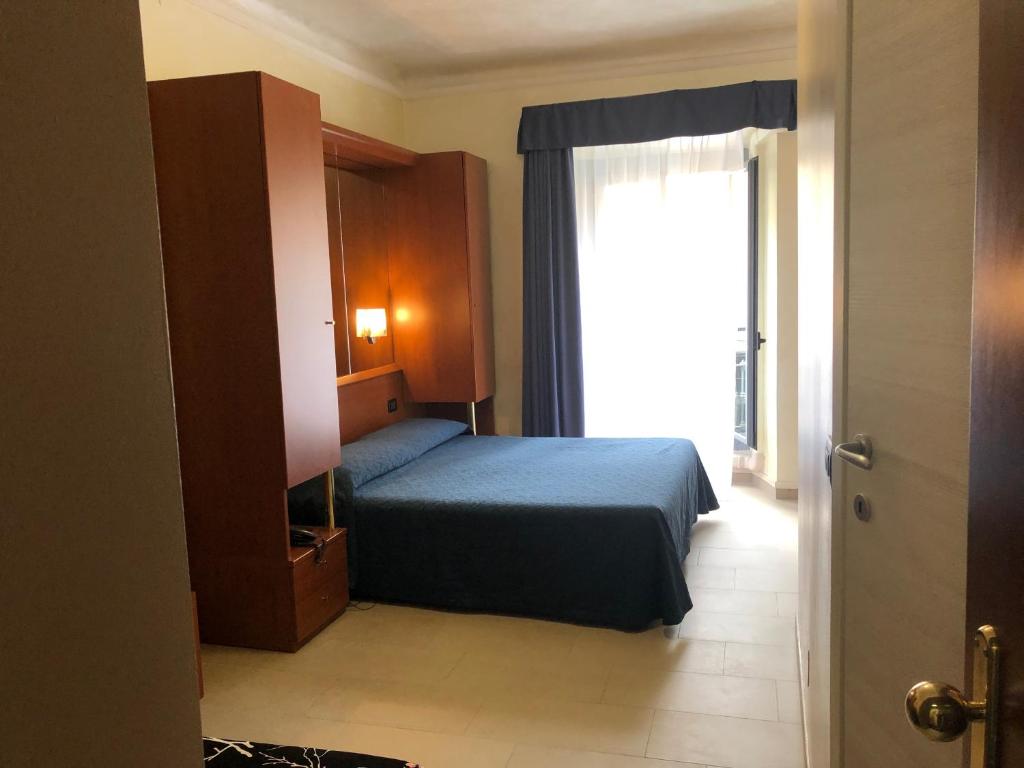 Postel nebo postele na pokoji v ubytování Hotel Aurora