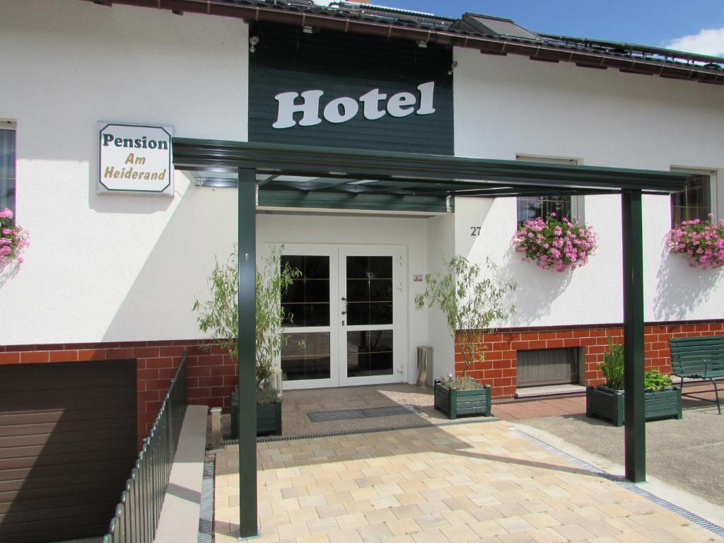 a hotel with a sign on the front of it at Pension Am Heiderand in Radeberg