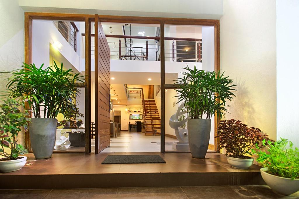 a hallway with potted plants in a house at Atrium Leisure in Boralesgamuwa