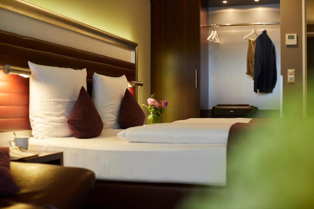 Postel nebo postele na pokoji v ubytování Hotel Metropol by Maier Privathotels