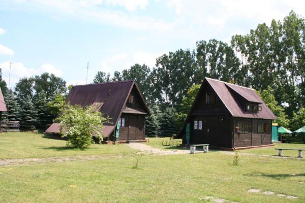 a couple of small buildings in a field at Ośrodek Wypoczynkowy KARINA in Pszczew