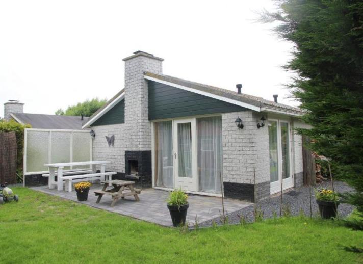 a house with a patio and a picnic table at Cosy Petten, Family only in Petten