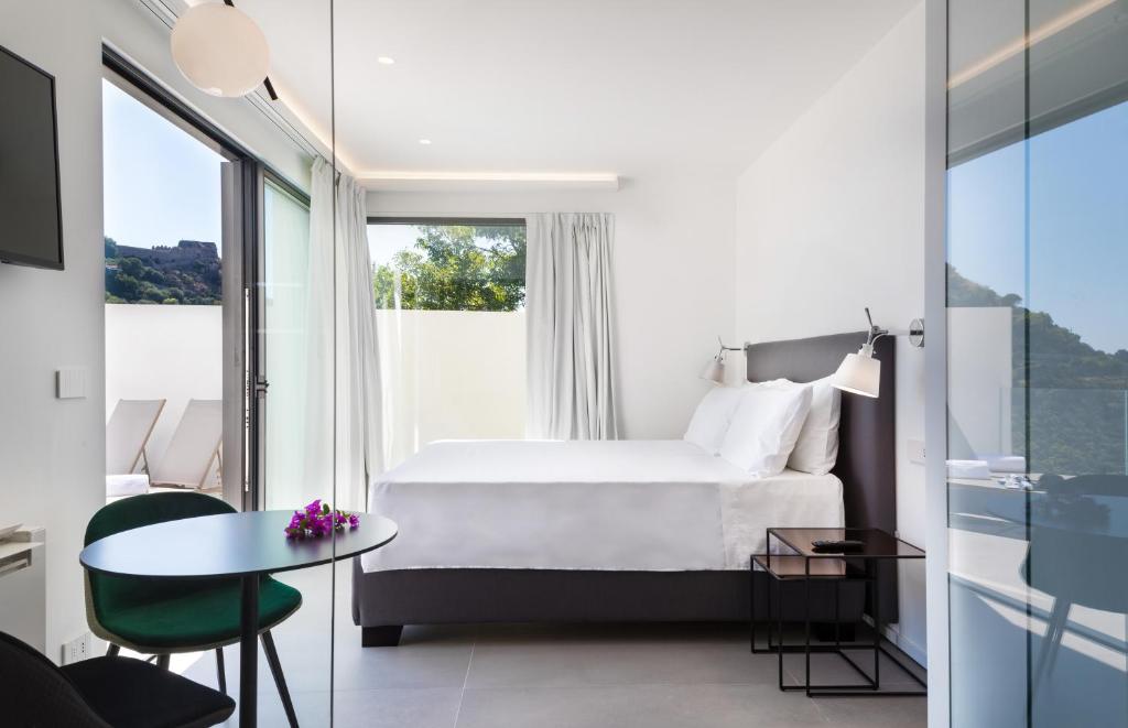 A bed or beds in a room at The View Luxury Apartments Taormina