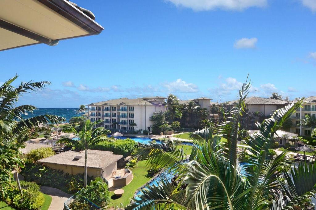 an aerial view of a resort with a swimming pool and the ocean at Waipouli Beach Resort Penthouse Exquisite Ocean & Pool View Condo! in Kapaa