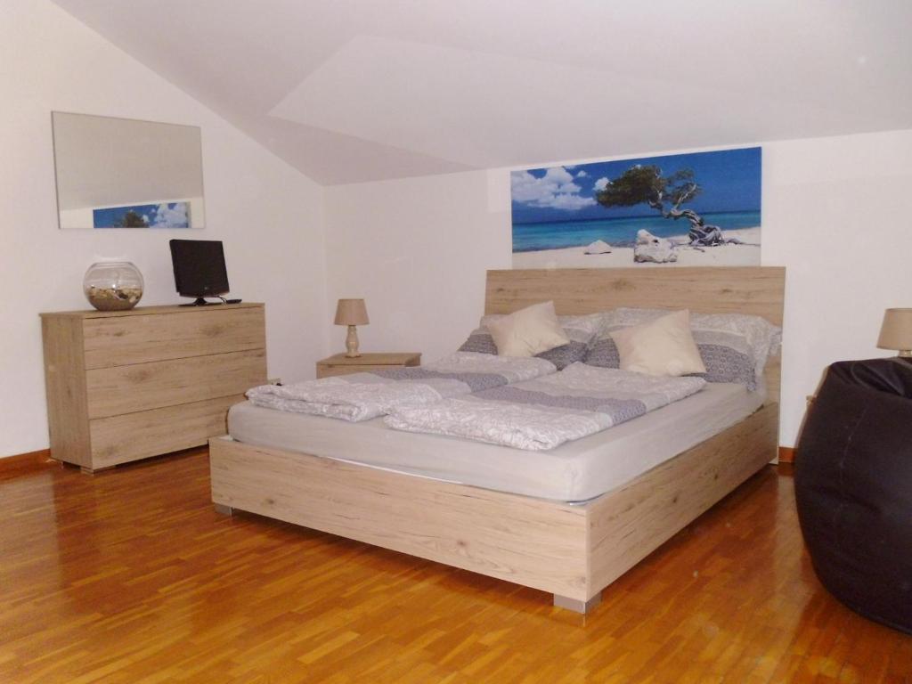 a bedroom with a large bed and a desk at El Campizòl in Drena