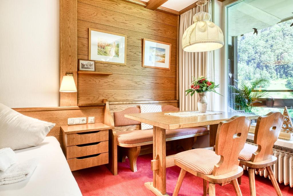 een eetkamer met een tafel en stoelen en een bed bij Appartment Studio Zentral by A-Appartments in Brand