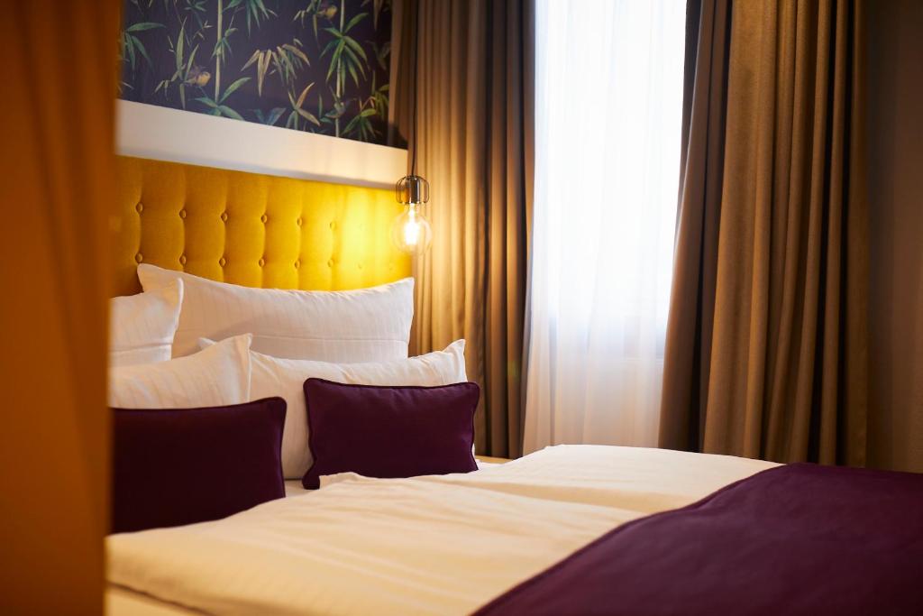 Postel nebo postele na pokoji v ubytování Hotel Mirabell by Maier Privathotels