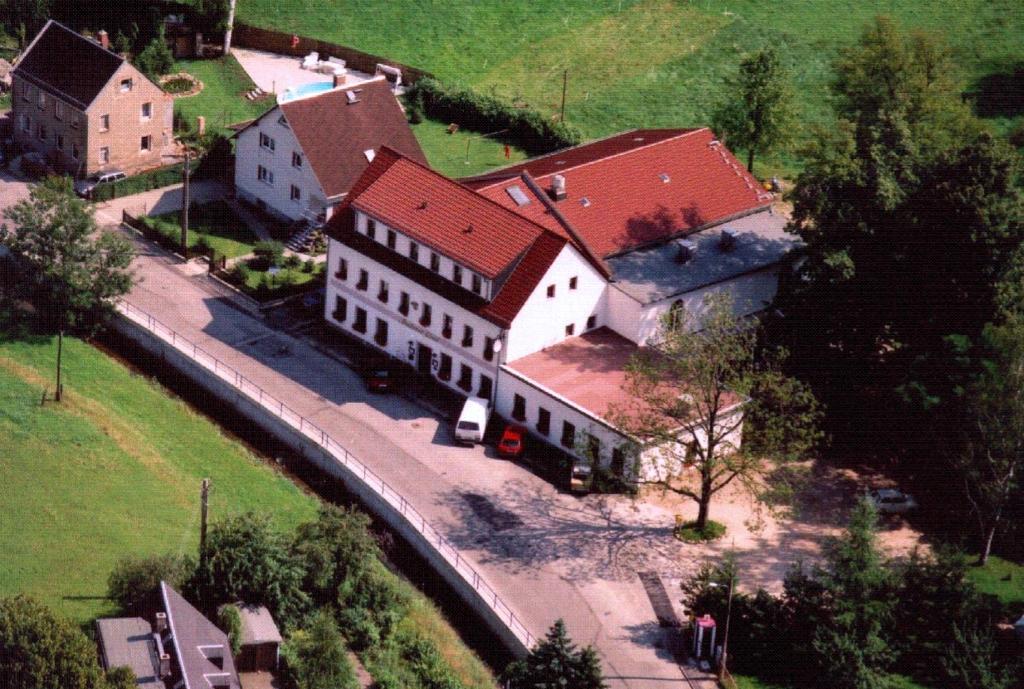 an aerial view of a large white building with a red roof at Landhotel Goldener Löwe mit Pension Am Taurastein in Burgstaedt