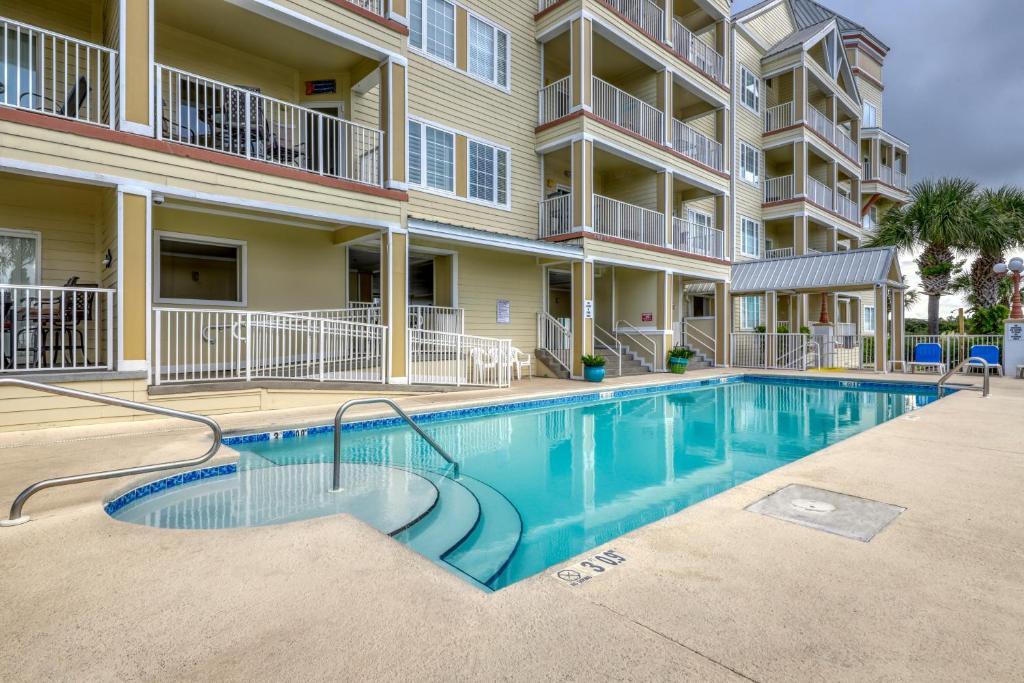 a swimming pool in front of a apartment building at Grande Caribbean in Orange Beach