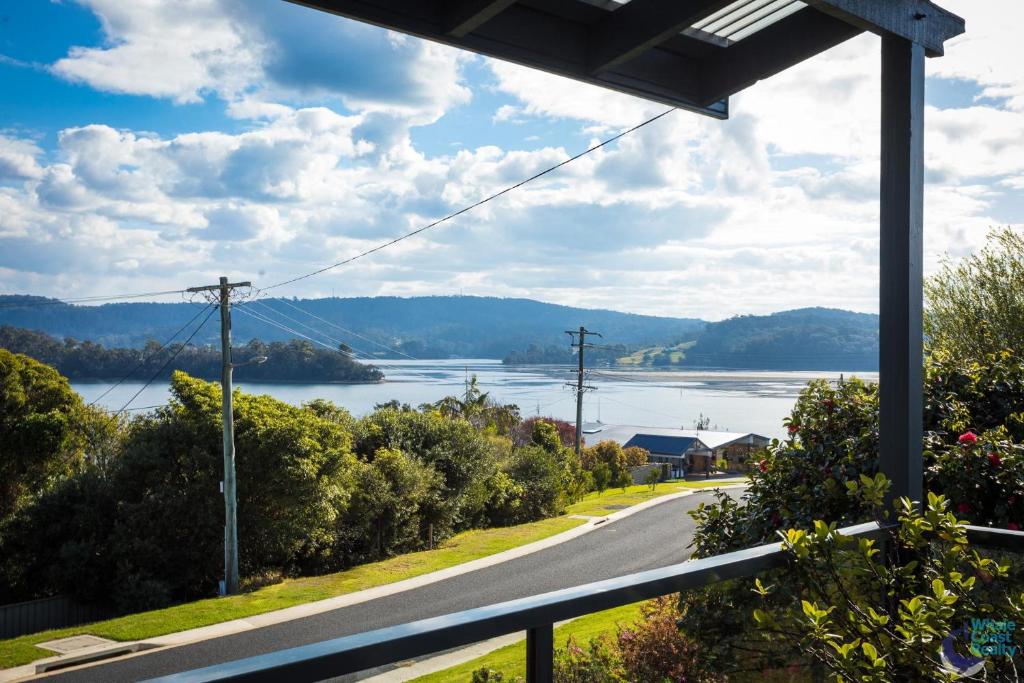 a view of a road and a lake from a house at Inlet Views at 20 The Loop in Narooma