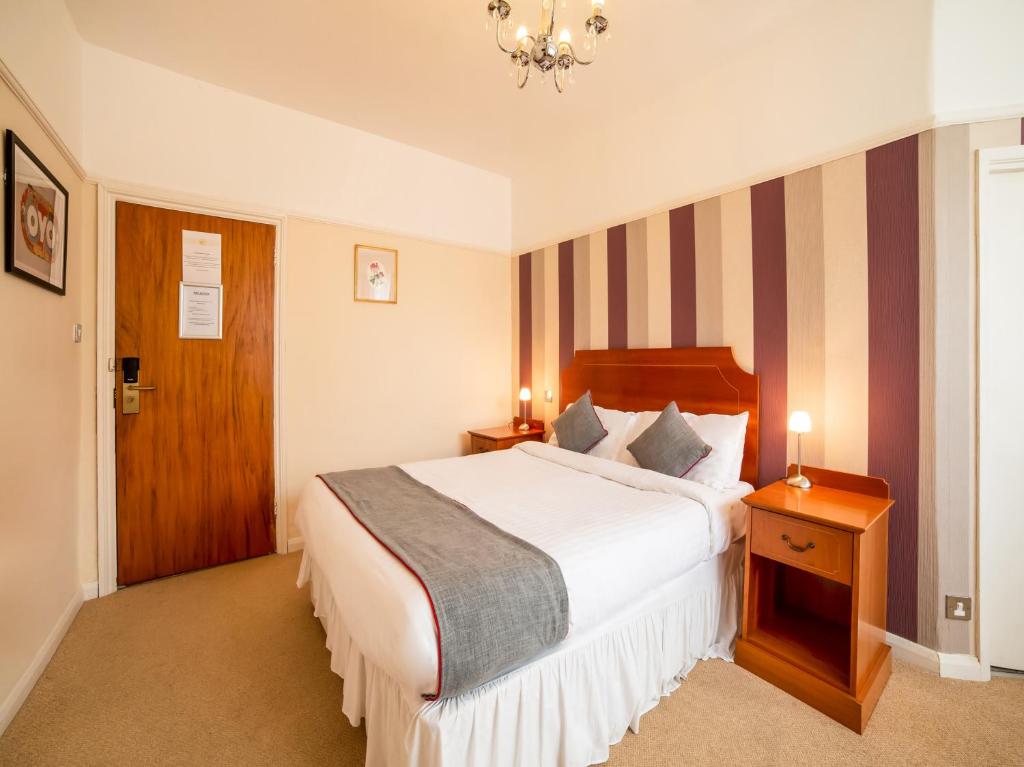 A bed or beds in a room at OYO Eagle House Hotel, St Leonards Hastings