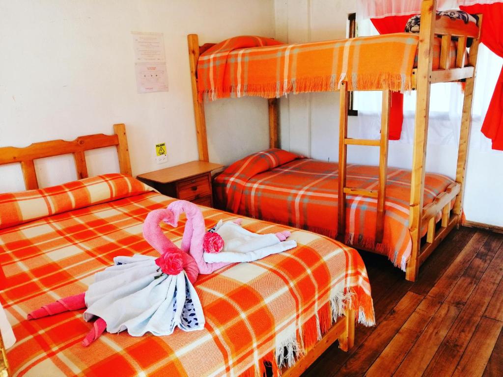 Postel nebo postele na pokoji v ubytování Hostal Taita Cristobal