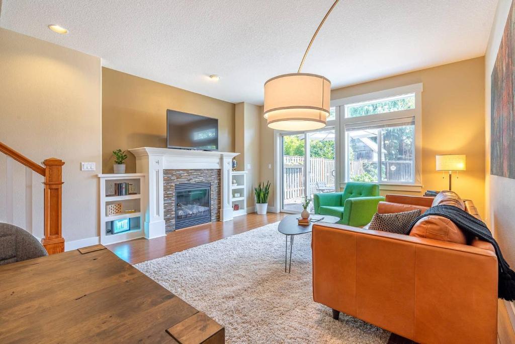 a living room with a couch and a table at Modern home, Four bedrooms, King Beds in Tigard