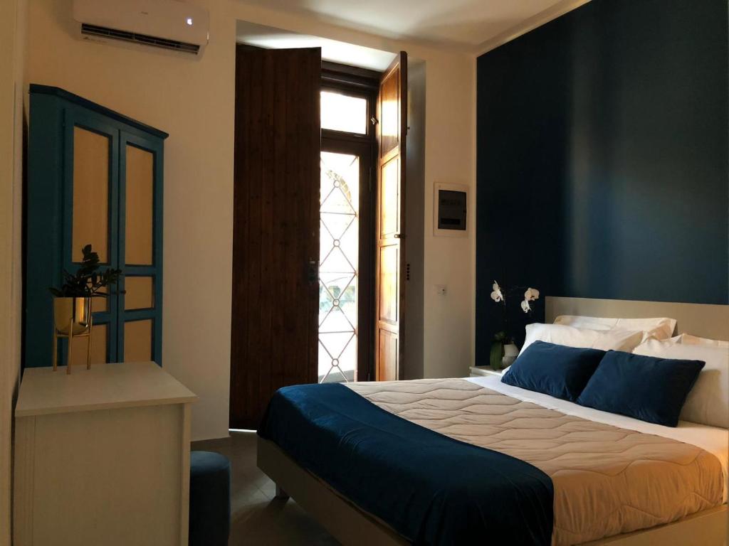 a bedroom with a large bed and a window at CIVITAS 2 in Catania