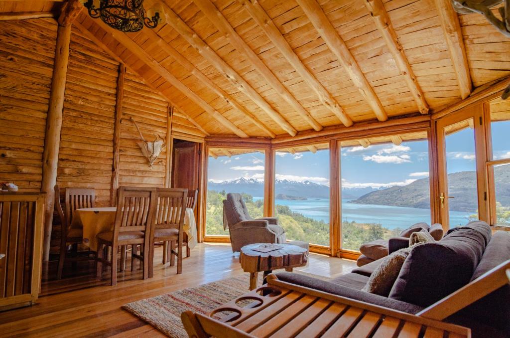 a living room with a view of the mountains at Mallin Colorado Ecolodge in Aldana