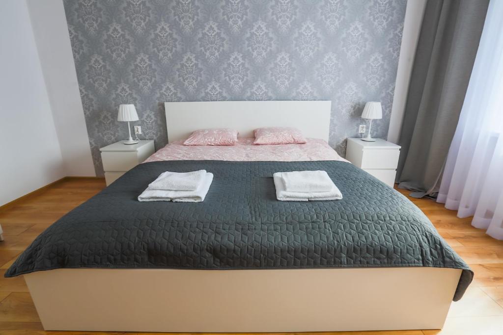 Posteľ alebo postele v izbe v ubytovaní Apartament Pod Winogronami