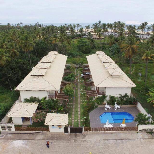an aerial view of a resort with a swimming pool at Residence Cotê d' Azur in Imbassai