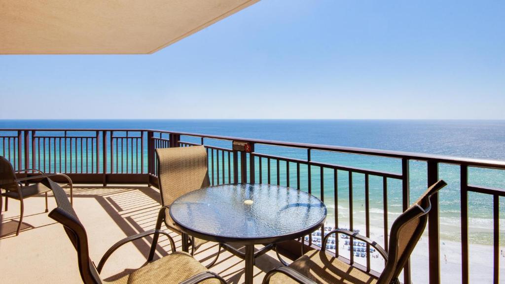 a balcony with a table and chairs and the ocean at Westwinds 4848 Su in Destin
