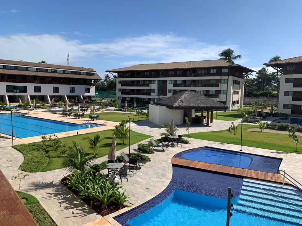 a view of a resort with two swimming pools at Cupe beach living in Porto De Galinhas