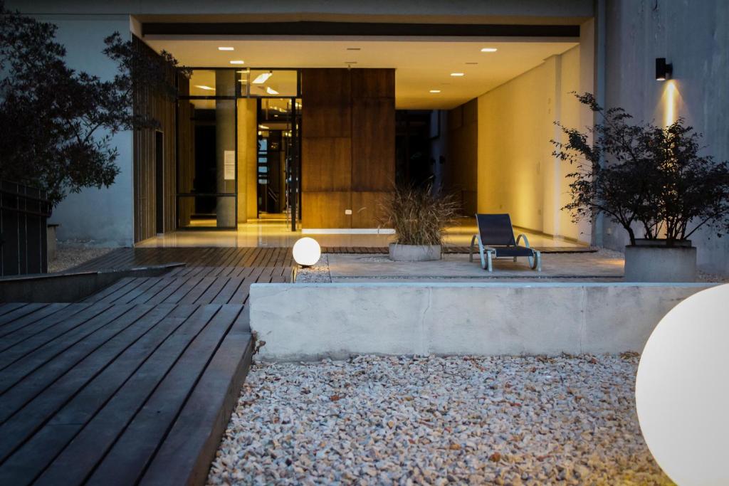 a lobby of a building with a chair in front of it at Apart Dorrego in Buenos Aires