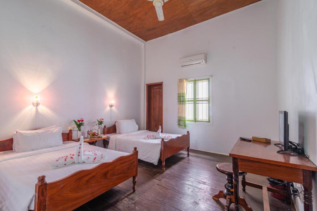 Postel nebo postele na pokoji v ubytování Five Rose Siem Reap Hostel