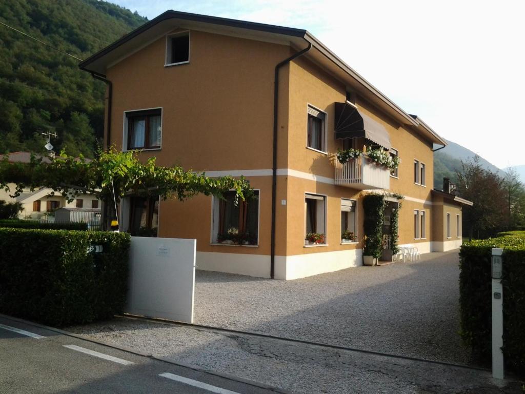 a large yellow building with a lot of windows at B&B La Palanca in Revine Lago