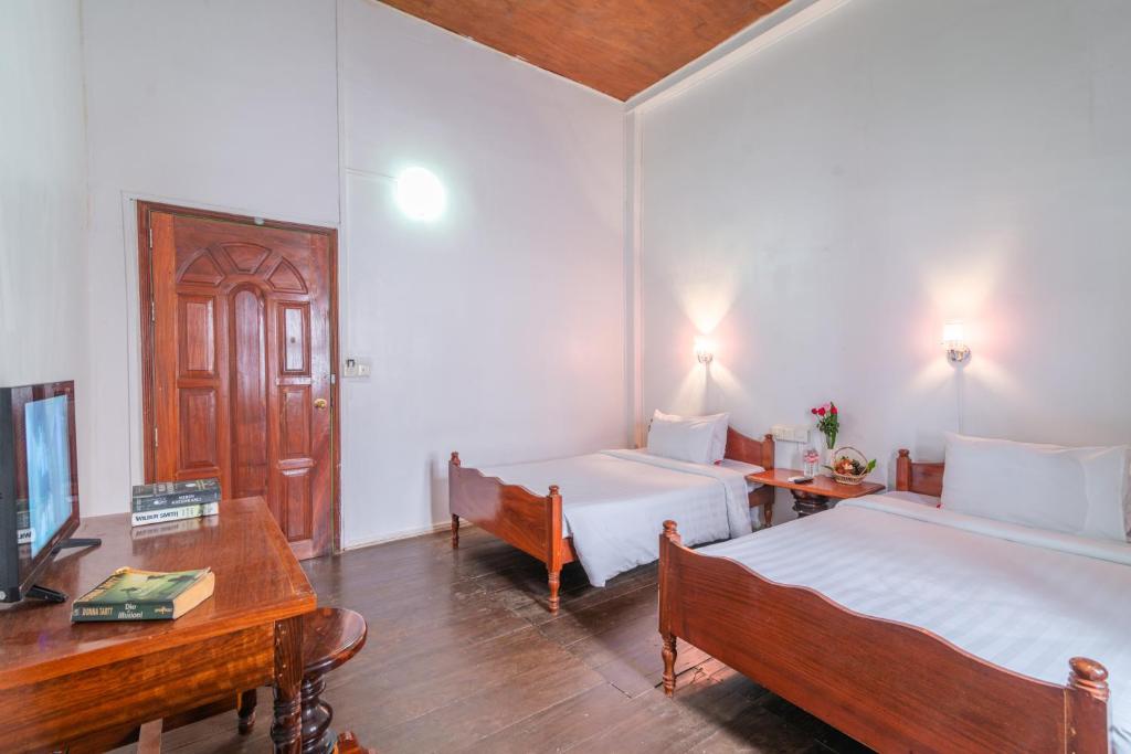 Postel nebo postele na pokoji v ubytování Five Rose Siem Reap Hostel