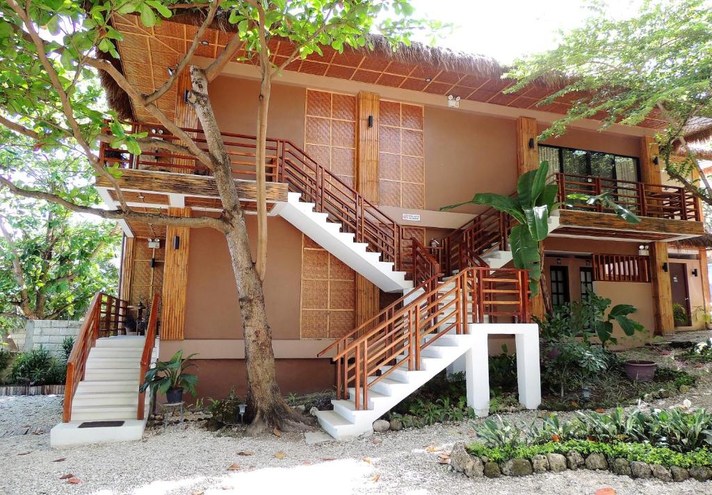 a house with stairs leading up to it at AJ's Place Beach Resort in Oslob