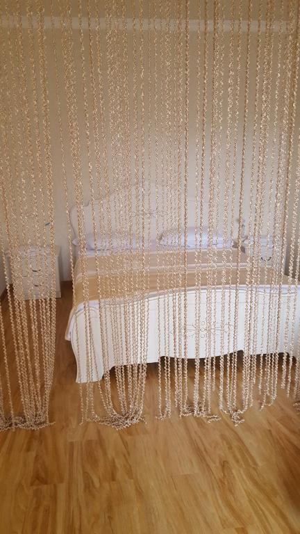 a white curtain with beads on a wooden floor at Hyuratun in Vanadzor