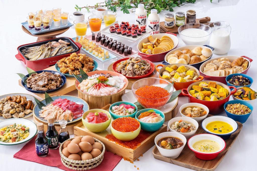 a table topped with lots of different types of food at Vessel Inn Sapporo Nakajima Park in Sapporo