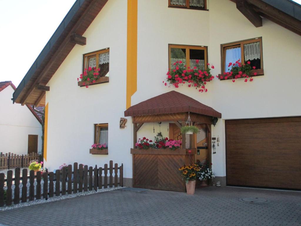 a house with a garage with flowers in the windows at Ferienwohnung Maria in Todtmoos