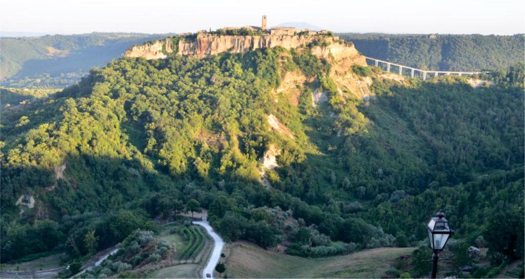 a mountain with a bridge on top of it at Le Calanque La Terrazza su Civita in Lubriano