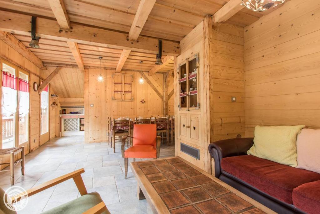 a living room with a couch and a table at Chalet la griotte in Abondance