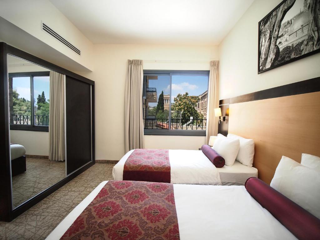 Postel nebo postele na pokoji v ubytování New Capitol Hotel - Jerusalem