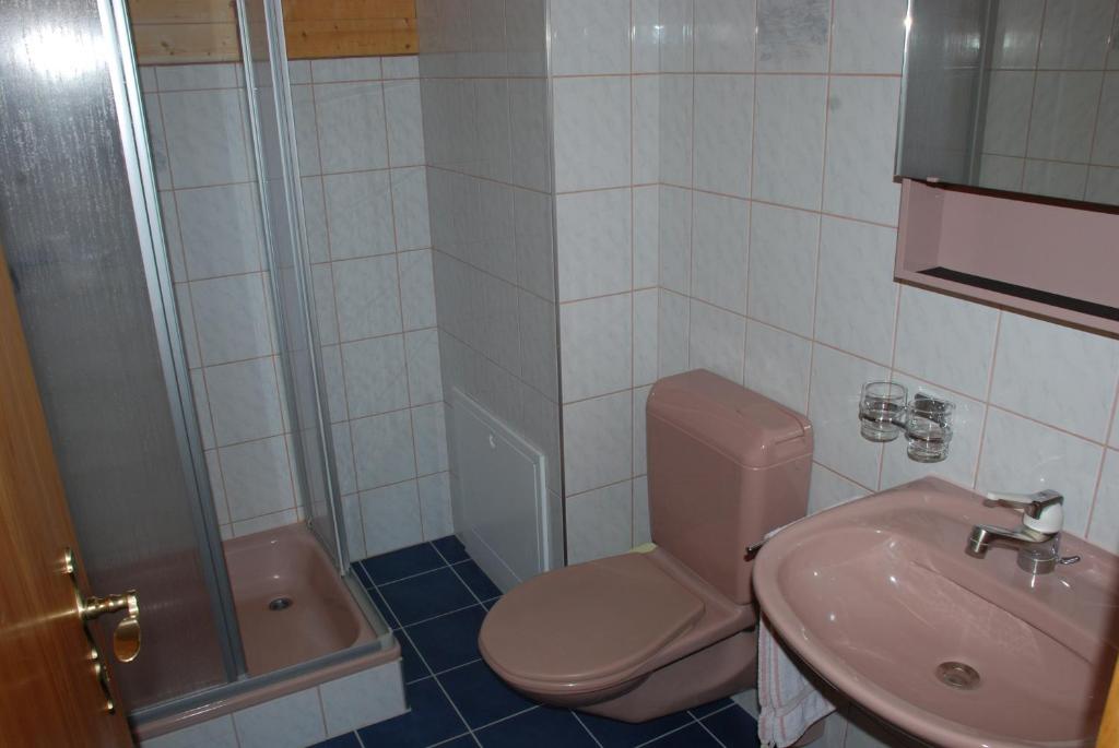 a bathroom with a pink toilet and a sink at Appartment & Taxi Tirana in Samnaun