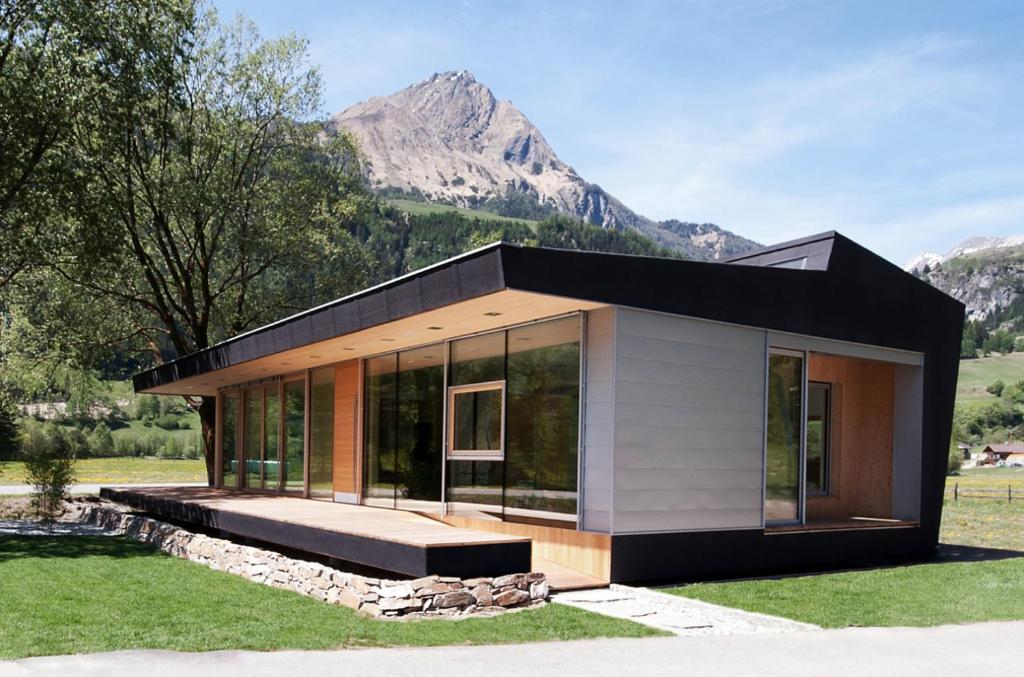 a small house with a mountain in the background at Designhaus COOP in Matrei in Osttirol