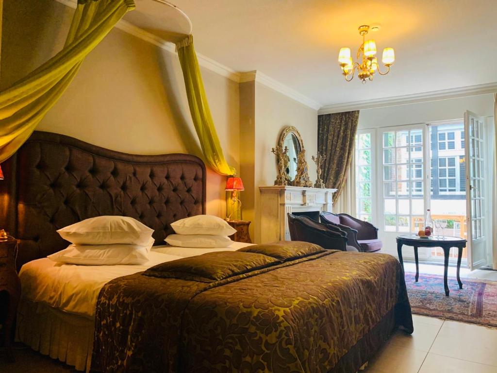 Postel nebo postele na pokoji v ubytování Boutique Hotel Die Swaene