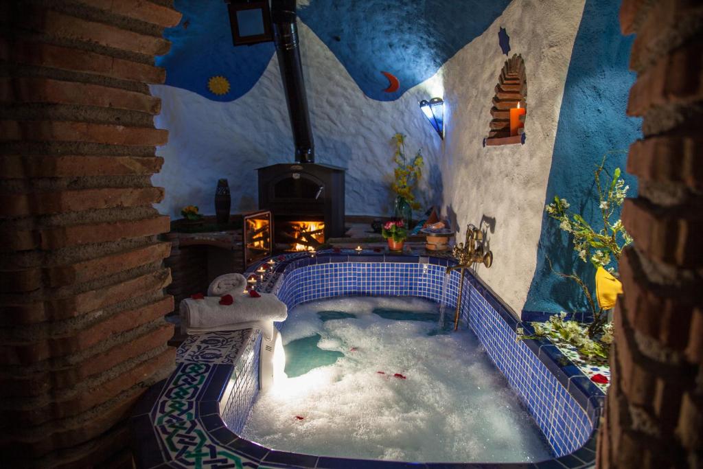 a room with a jacuzzi tub in a house at Casas Cueva Cazorla in Hinojares